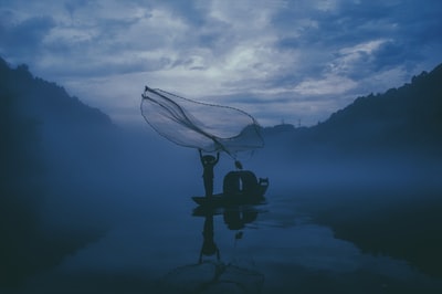 夜间在水中钓鱼的人